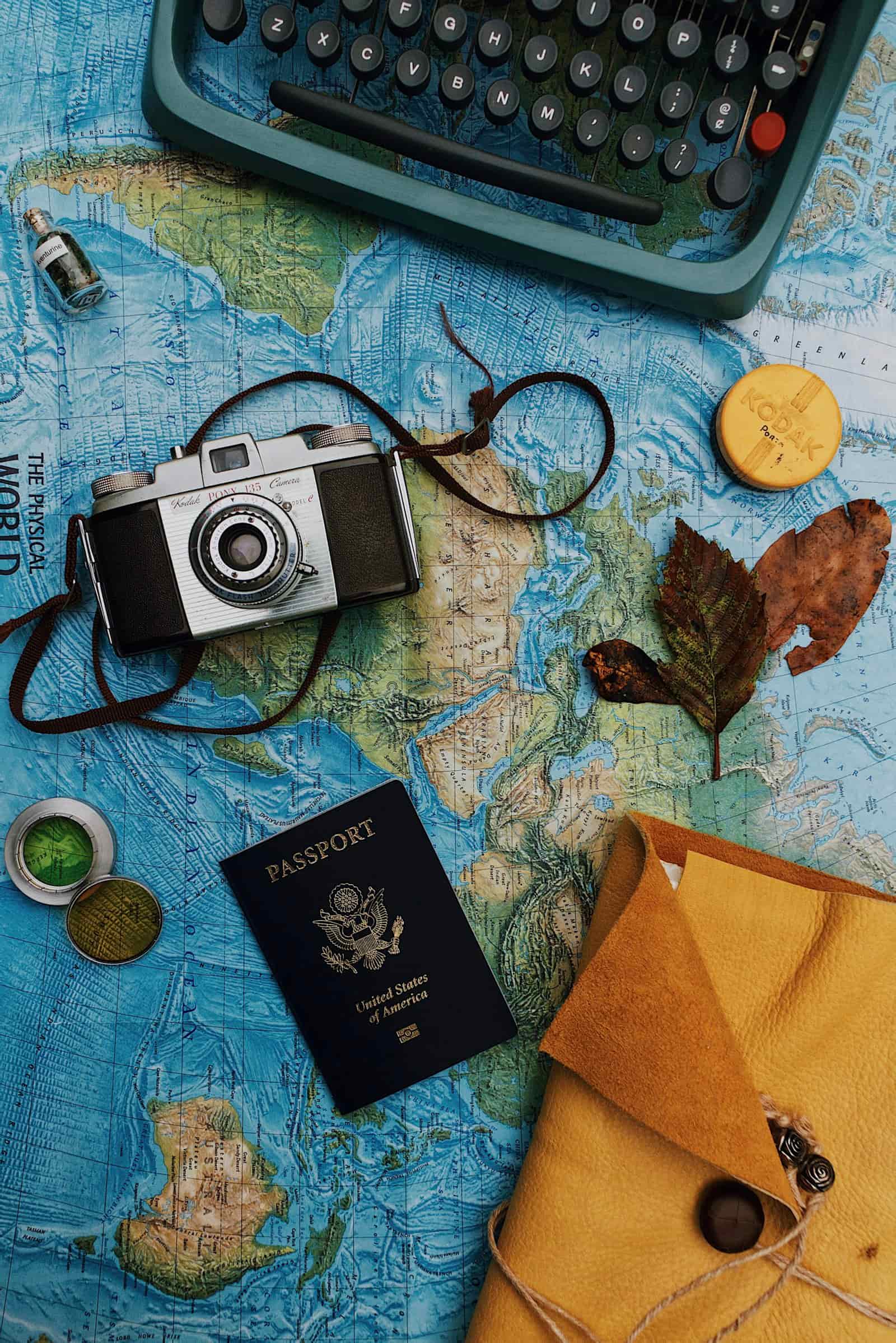 Camera, laptop and passport for a practical travel advisor marketing plan