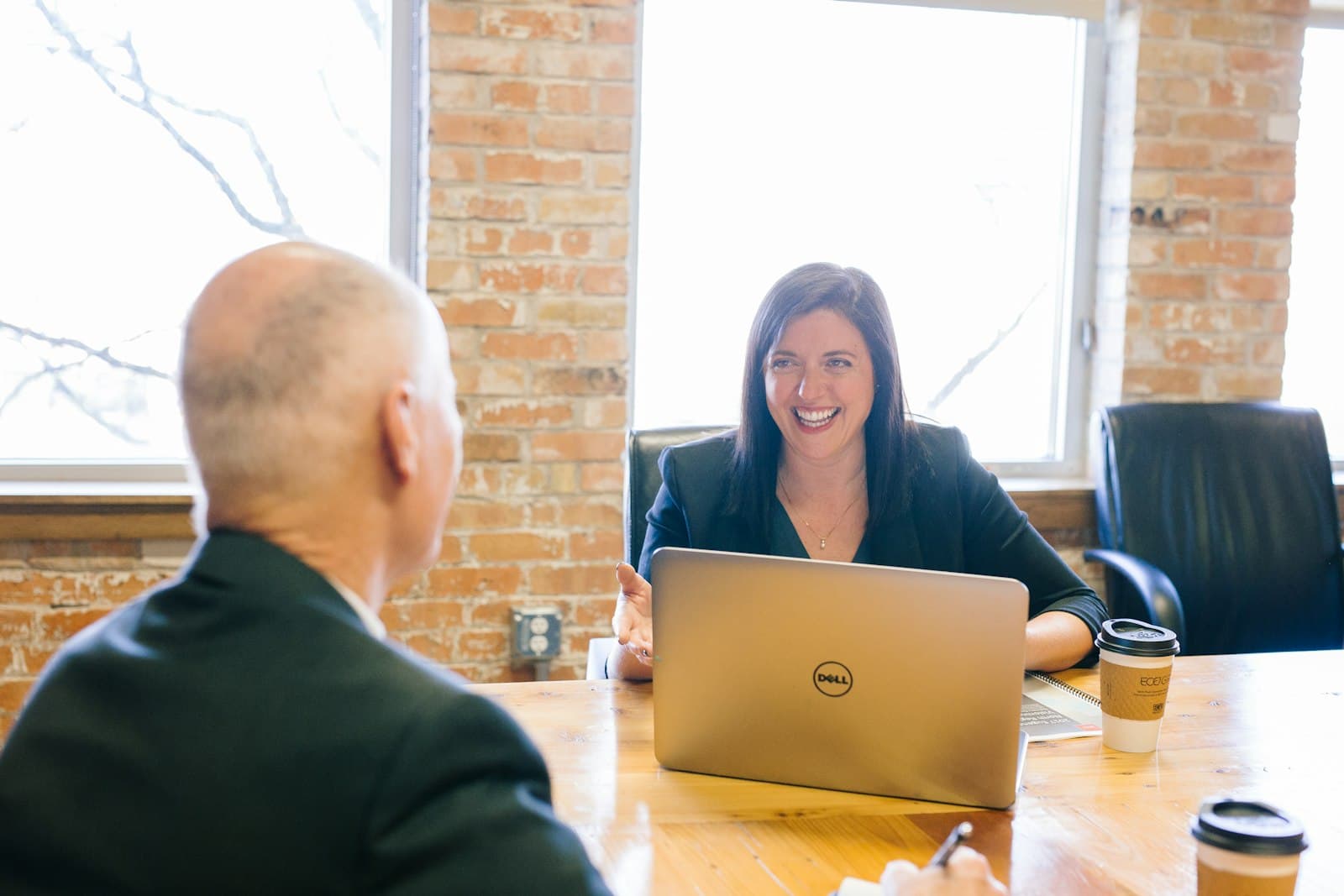 An advisor in a one-on-one conversation with a client, listening for the why behind the trip before talking dates and destinations.