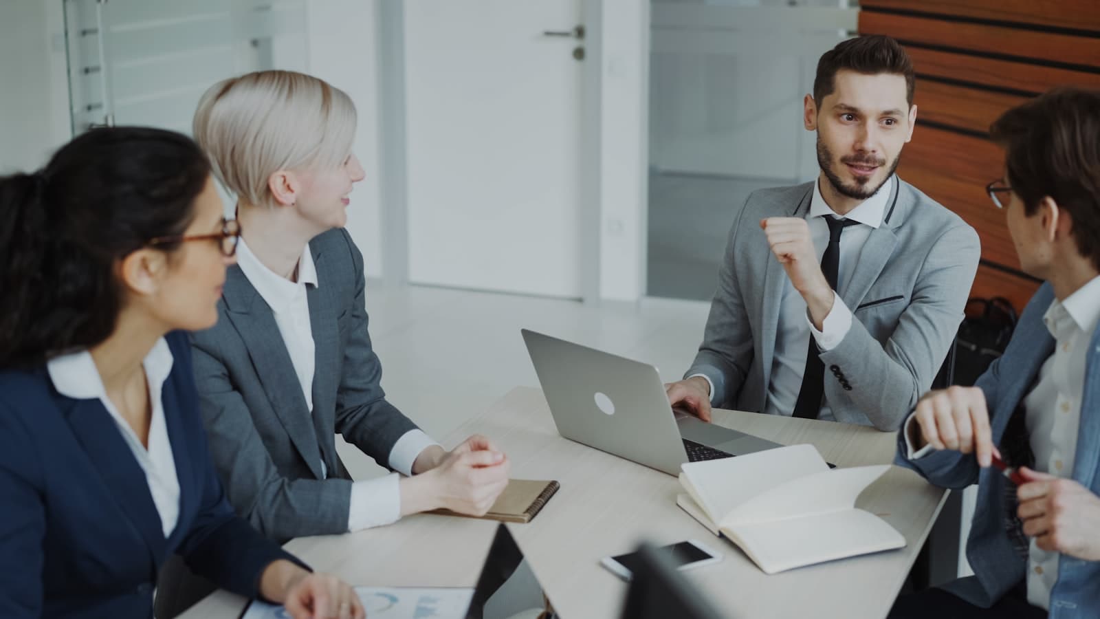 Professionals discussing a repeatable client process around a table