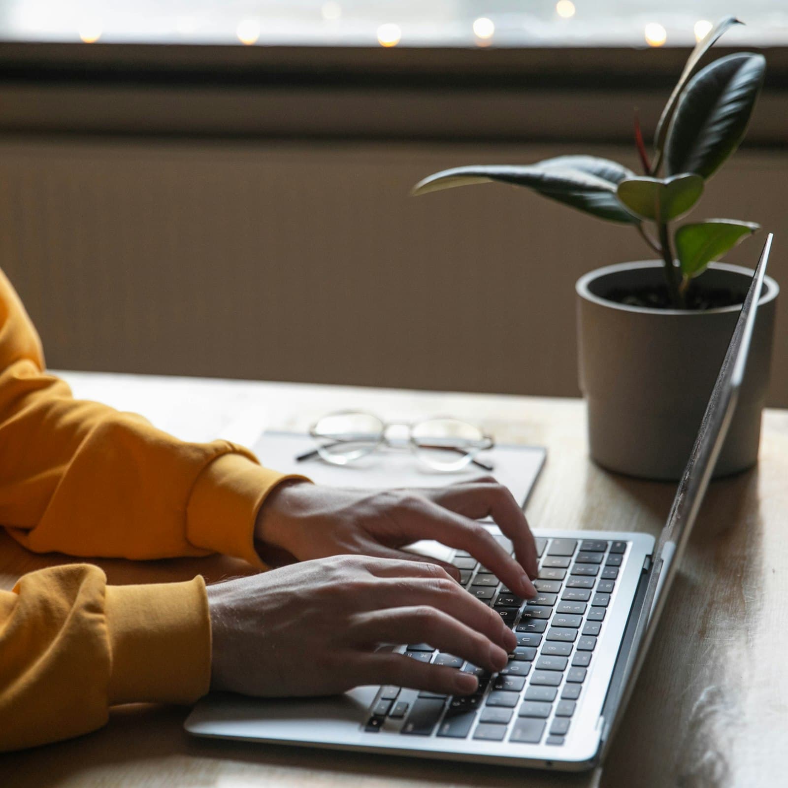Typing an automated enquiry or payment reminder email on a laptop Typing an automated enquiry or payment reminder email on a laptop