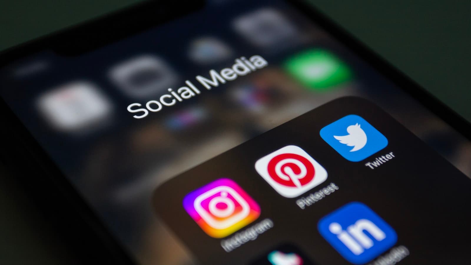 Social media apps on a phone screen, the feed a post either cuts through or disappears into Social media apps on a phone screen, the feed a post either cuts through or disappears into