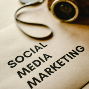 "Vintage camera on desk with 'Social Media Marketing' text, symbolizing digital marketing strategy for travel agencies"