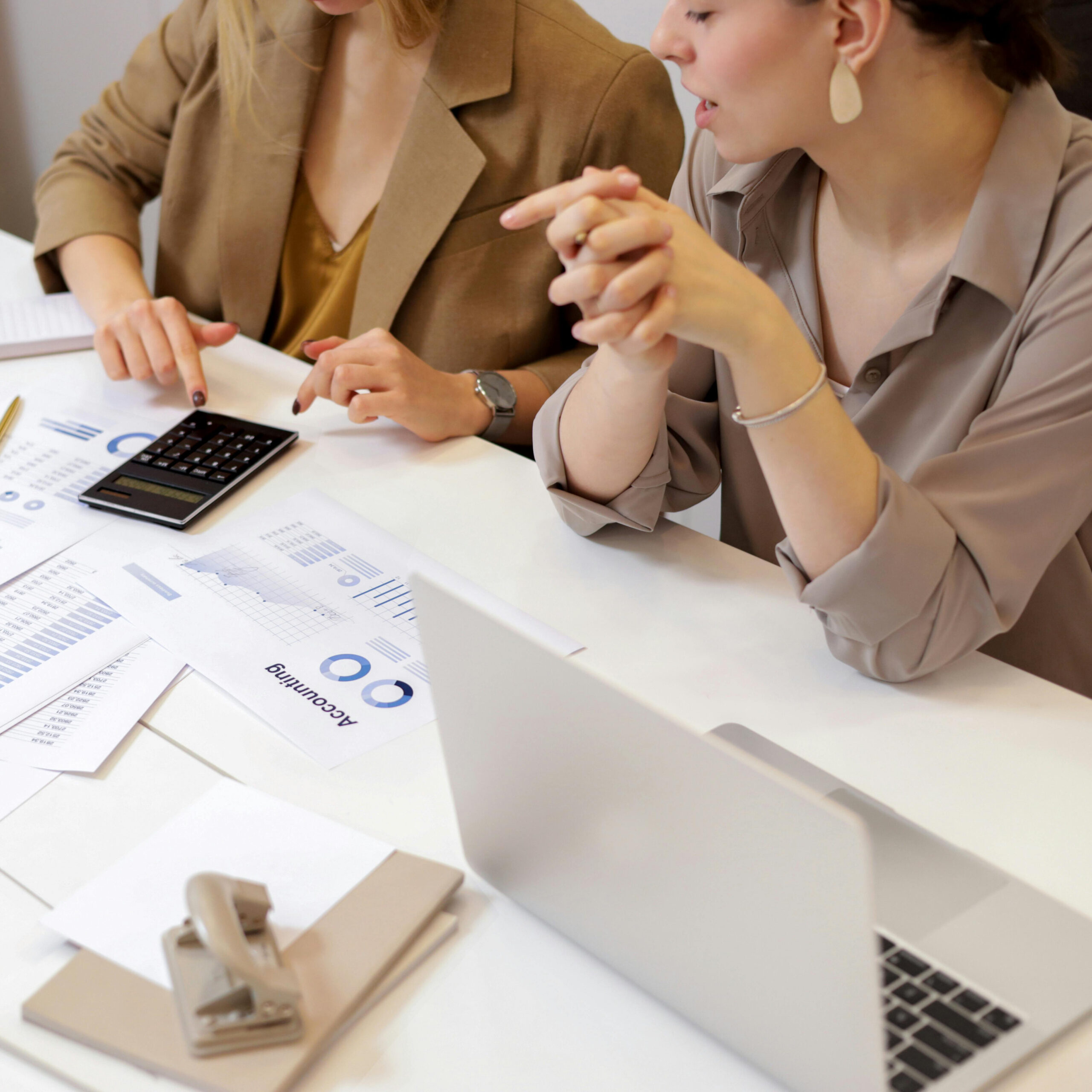 Two business professionals analysing data and discussing trip planning services strategies.